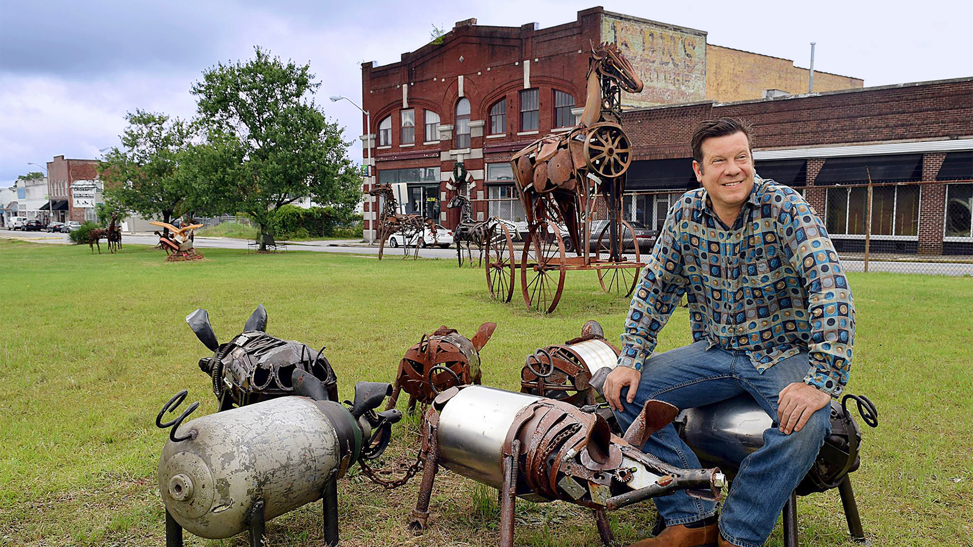 Artist Jonathan Bowling with his rustic metal sculptures.